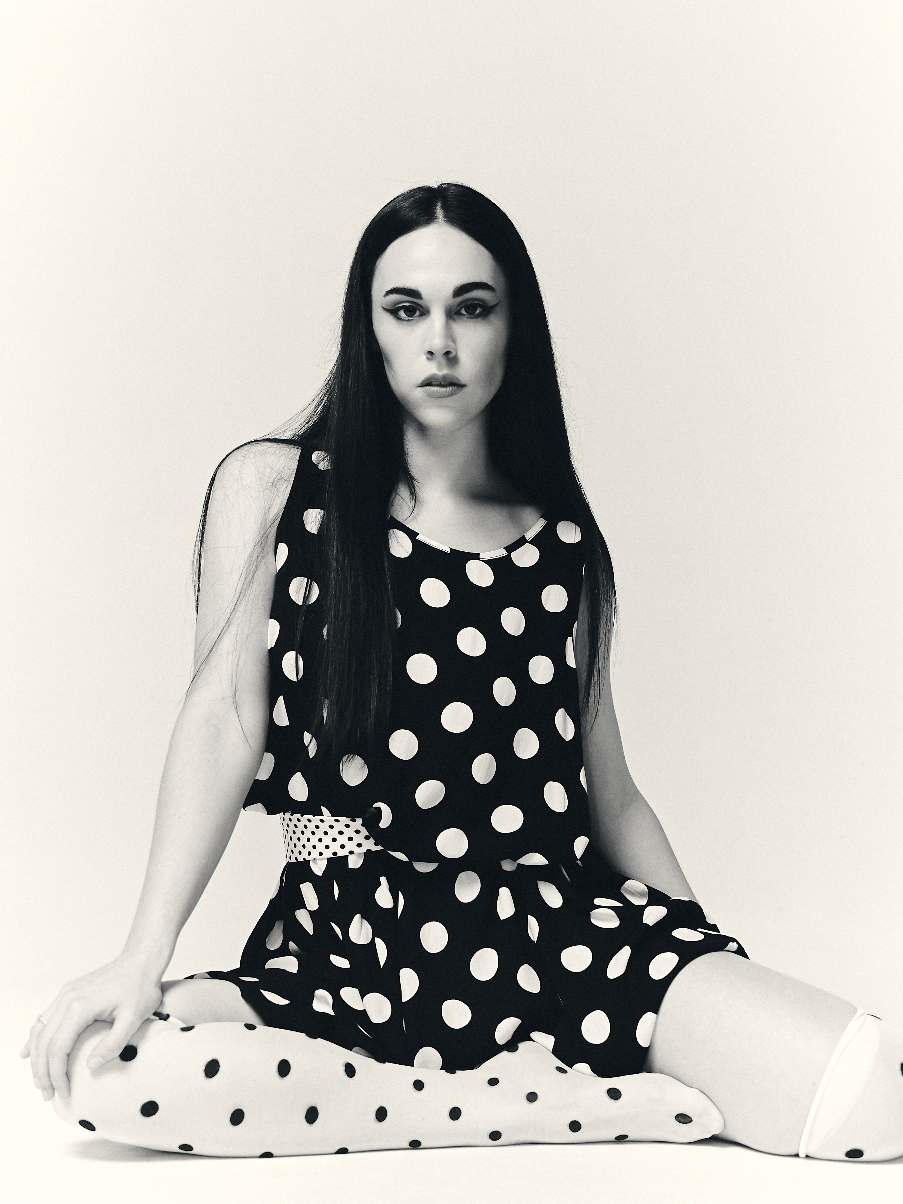 Black and white editorial close-up with polka dot styling and sculptural composition