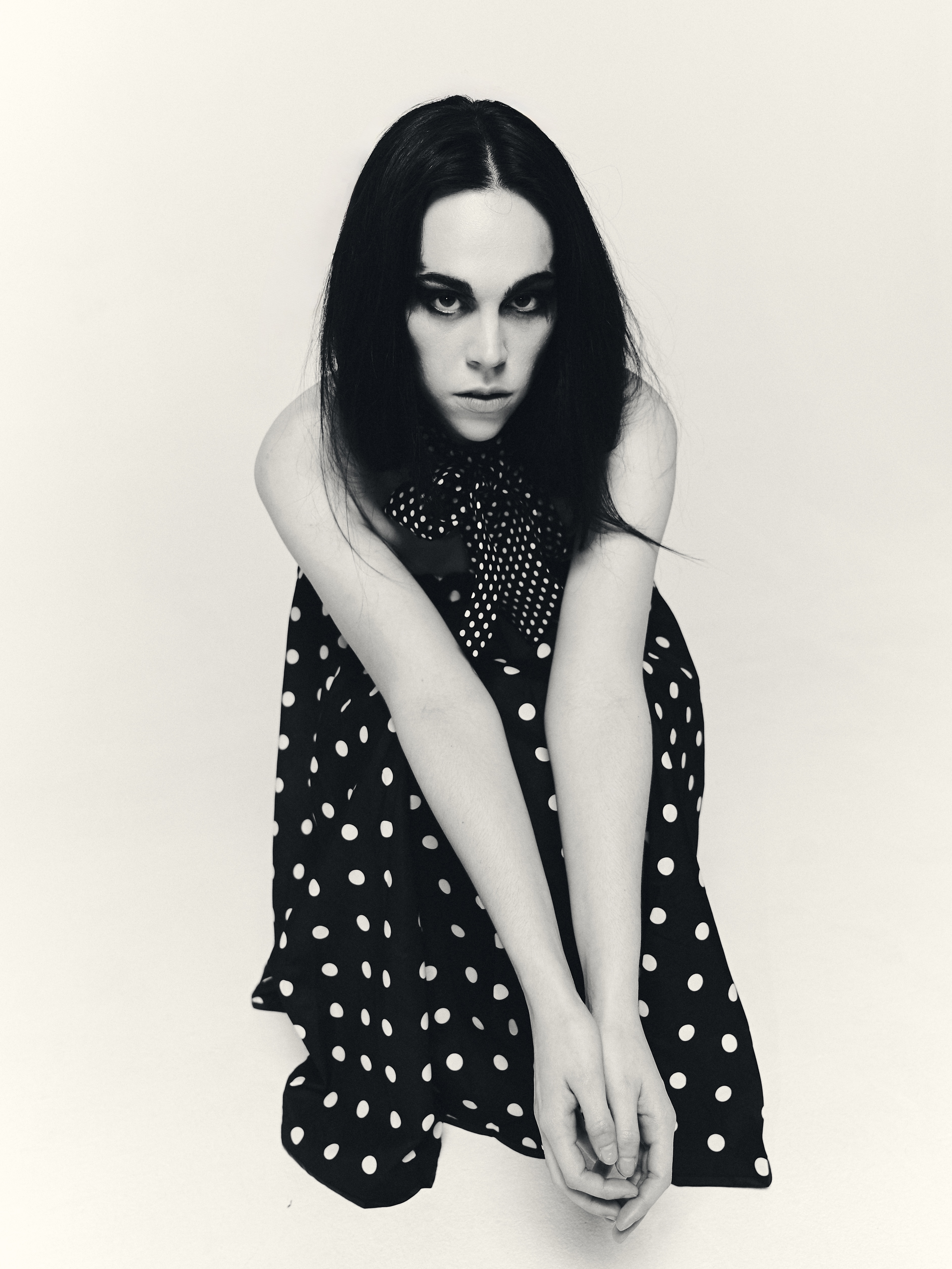 Fashion editorial photography with sculptural silhouette and black and white contrast
