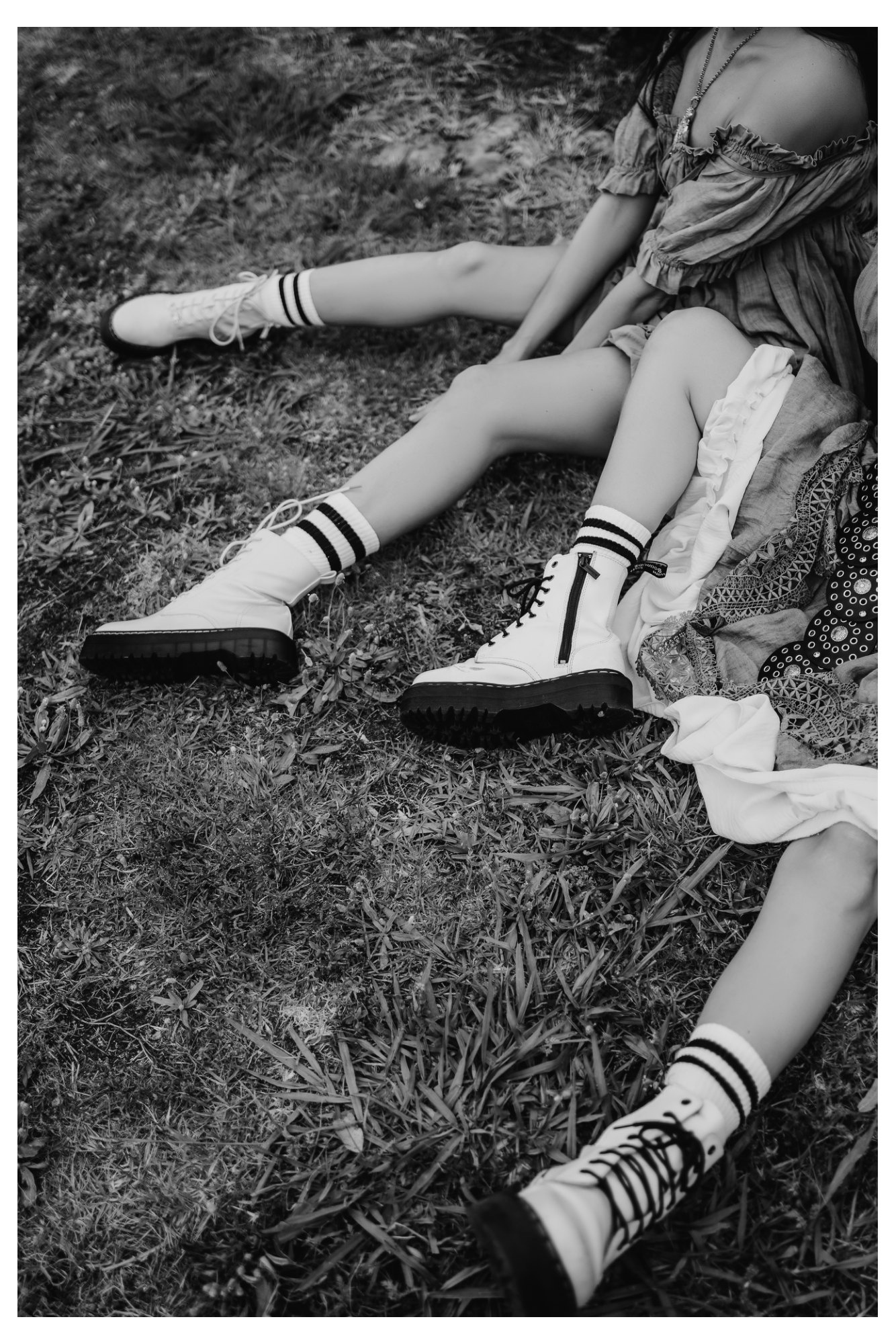 Detail of sports socks and chunky boots styled in a black-and-white fashion editorial